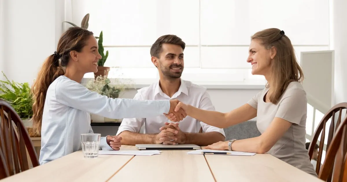 people shaking hands in agreement after a successful mediation.