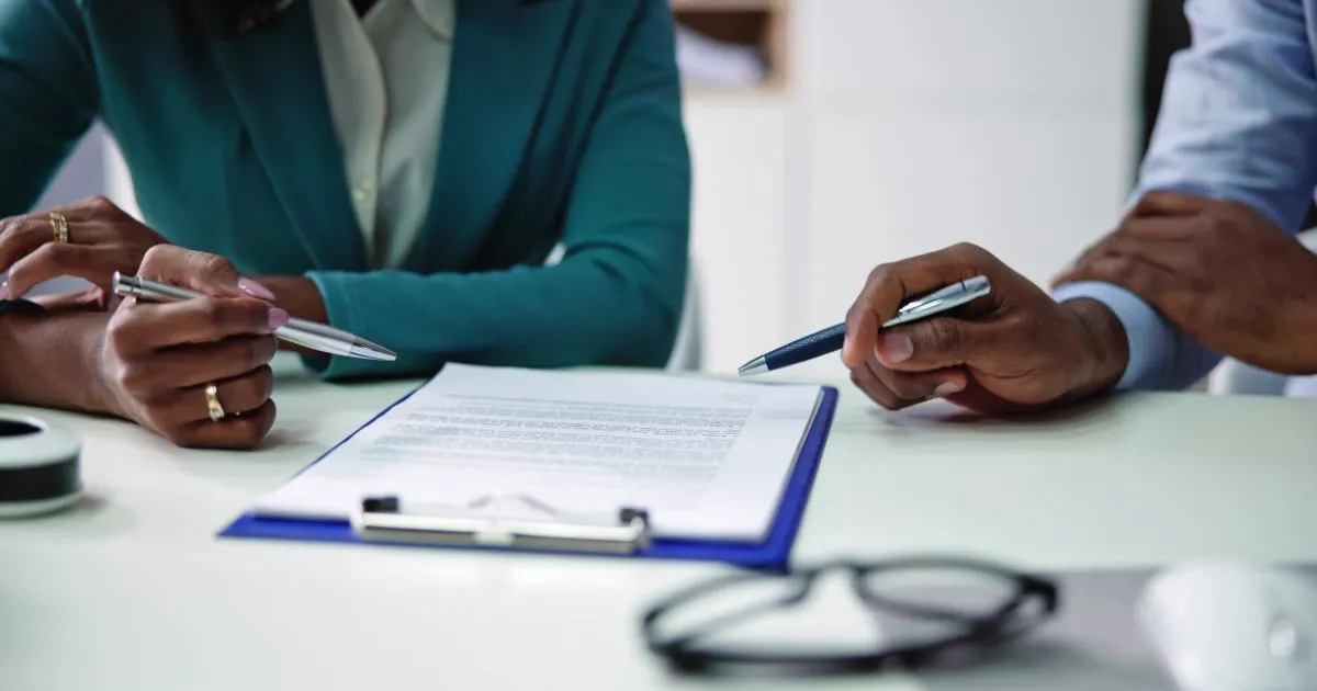 2 individuals analyzing paperwork