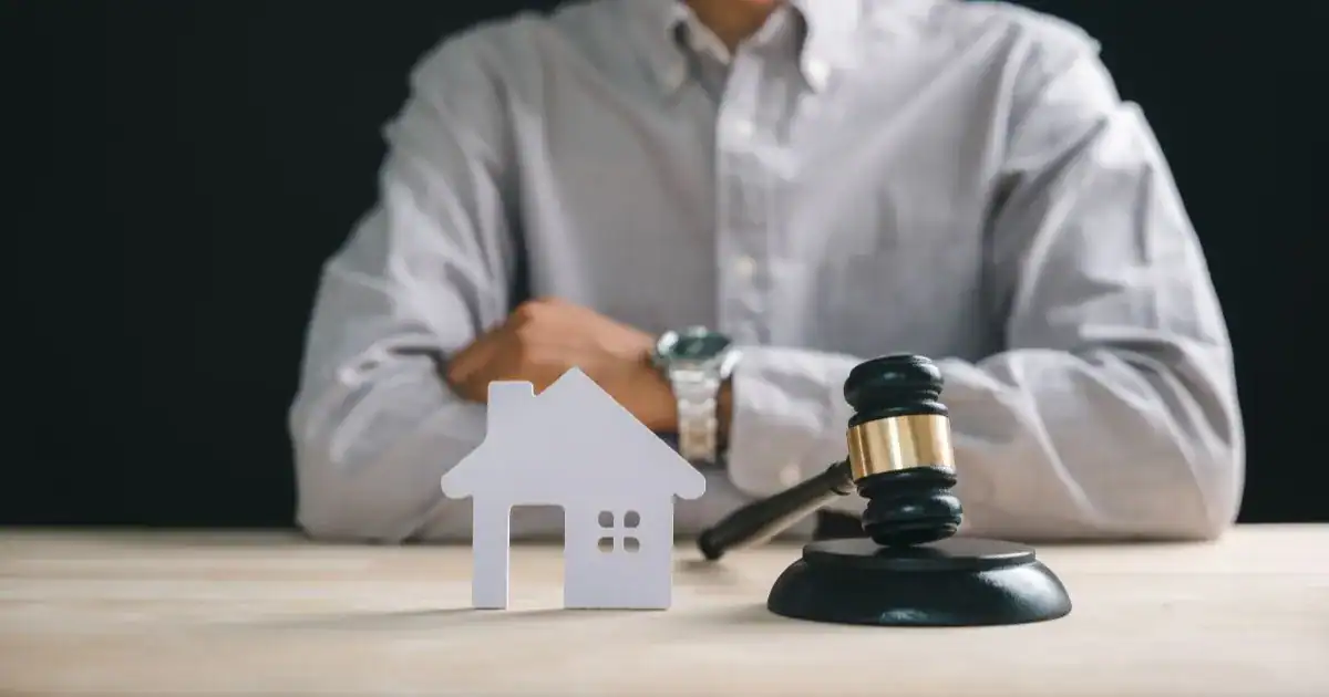 man with his arms crossed having to go through the divorce process.